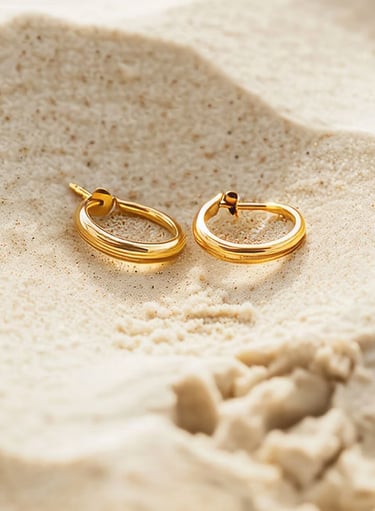 a pair of gold hoop earrings with a gold hoop earrings