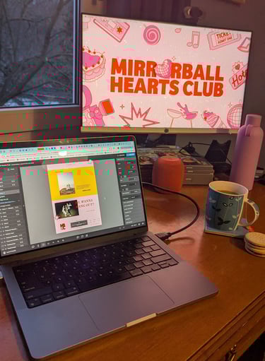 A laptop open to Show It website builder. Mirrorball Hearts Club is being designed on screen.