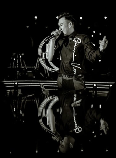 a man in a suit and tie is holding a microphone