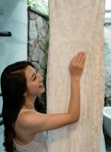 a woman is holding a dress on a hanger