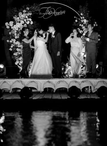 a bride and groom standing on a stage