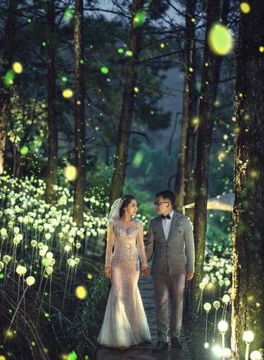 a bride and groom walking through a forest