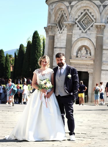 a man and woman standing in front of a church