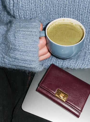 relax while you system runs automated. SAHM with drink and closed laptop relaxing