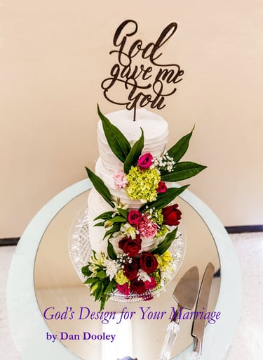 Elegant tiered white wedding cake with fresh red roses and a God Gave Me You topper.