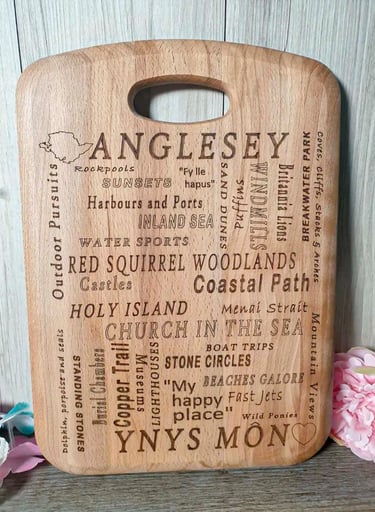 A chopping board with a unique design, the engraving showing Anglesey with things to do and see