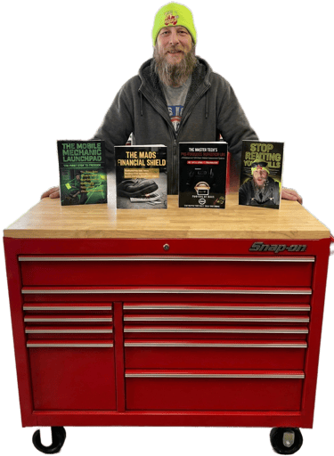 Fast T and his 4 published books on top of a red Snap-On toolbox