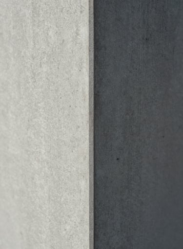 Close-up macro photography of a concrete pillar texture meeting a sharp metal edge, architectural detail, soft shadows, light gray and medium gray tones, editorial style, North American / European.