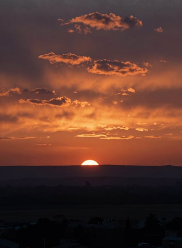 A wide cinematic landscape from one of Frank Artus's major film productions. The colors are rich and dramatic, featuring a sunset sky with deep oranges and dark silhouettes (#1A1C20), evoking a sense of epic storytelling.