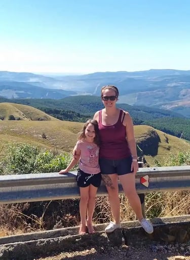 woman standing with child in front of view