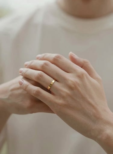 An intimate, close-up shot of two hands gently holding each other, focusing on the skin's texture and a simple gold ring. Soft, warm natural lighting. Palette includes #F8F5EF and #C8B6A6.