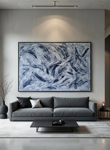 Modern living room with a large blue abstract wall art piece above a charcoal gray sofa and minimalist coffee table.