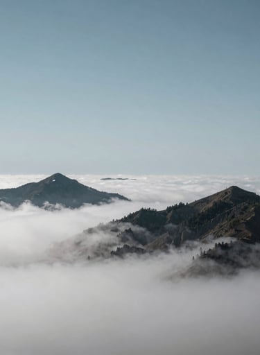 A breathtaking landscape of mountain peaks emerging through a layer of soft white clouds, minimalist composition, steel blue grey sky, International / Western.