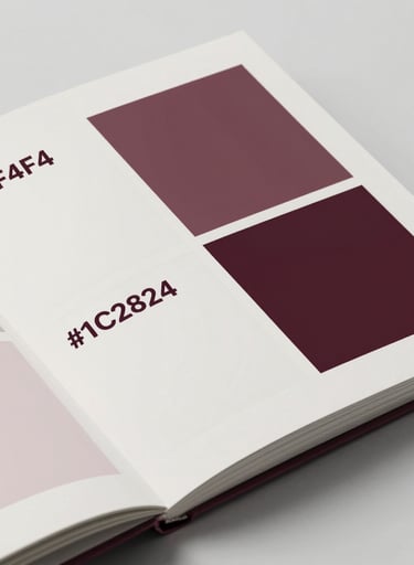 An open design book lying on a neutral surface, showcasing a grid-based layout. The paper texture is visible. Lighting is soft and even. Colors: #F0F4F4 paper with sharp #1C2826 text blocks.