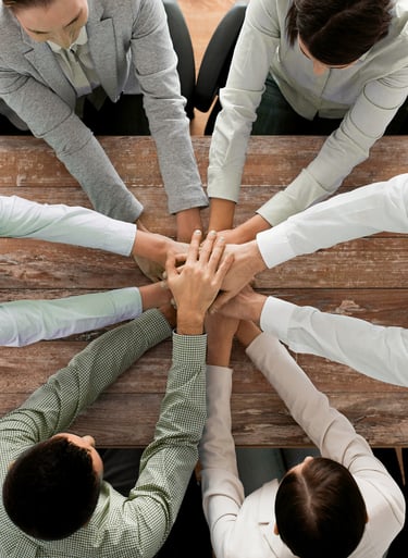 a group of business people sitting around a table