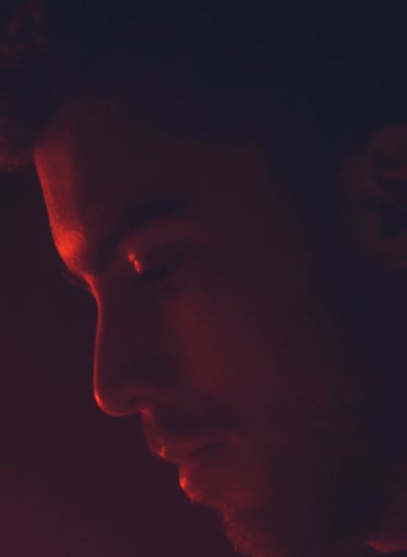 a man in a black shirt and red light