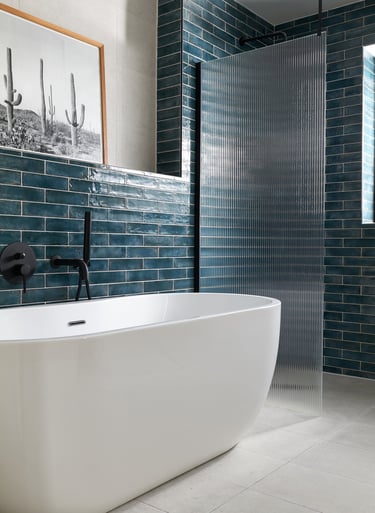 deep, glossy teal metro tiles, laid in a horizontal stack with white grout and fluted shower screen