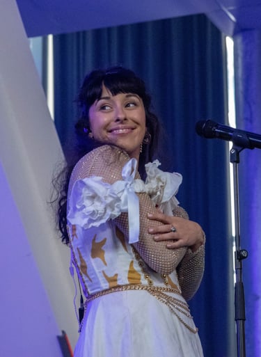 a woman in a white dress and a microphone