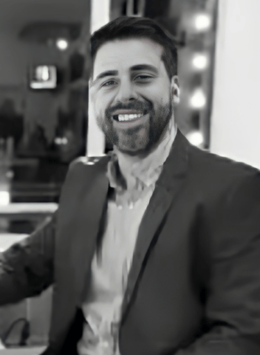 a man in a suit and tie smiling at the camera alejandro lange