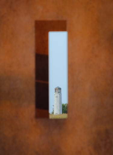A lighthouse shot through an bronze urban sculpture. Framing looks cool.