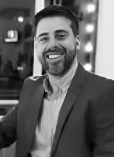 a man in a suit and tie smiling at the camera alejandro lange