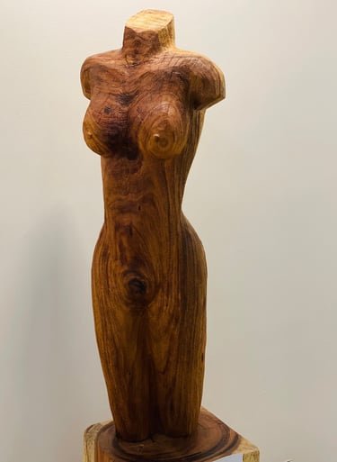 a wooden sculpture of a woman's torso