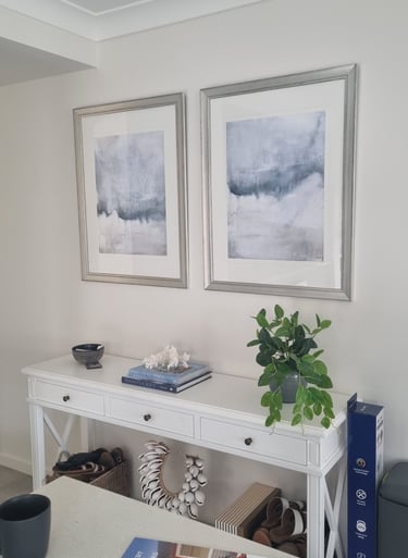 two pictures hanging straight with silver frame