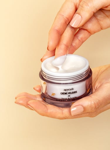 a person holding a jar of face cream in their hands and show the texture