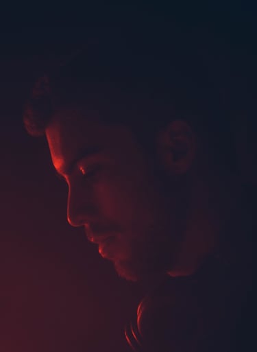 a man in a black shirt and red light