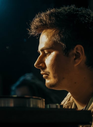 a man sitting at a table with a laptop
