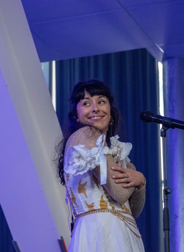 a woman in a white dress and a microphone