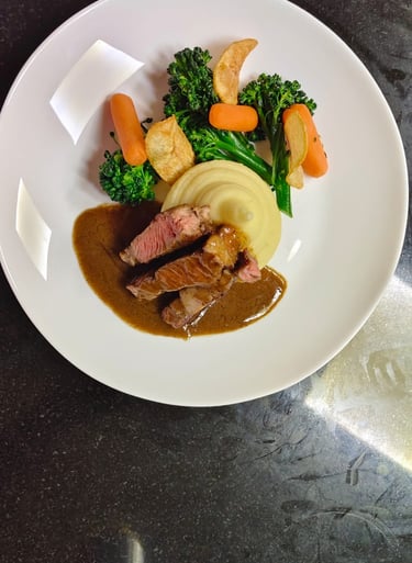 Professional Plating of a Rib Eye Steak with mashed potato and side vegs made at Upskill Hospitality