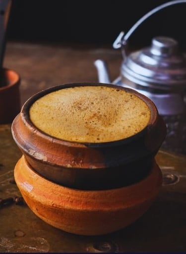 a cup of coffee with a teapot and a teapot