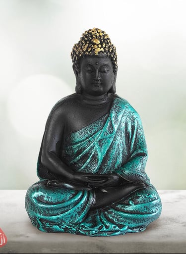 a statue of a buddha statue sitting on a table