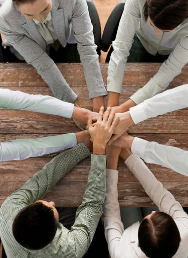 a group of business people sitting around a table