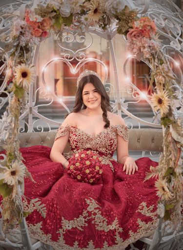 a woman in a red quinceanera dress sitting in a carriage