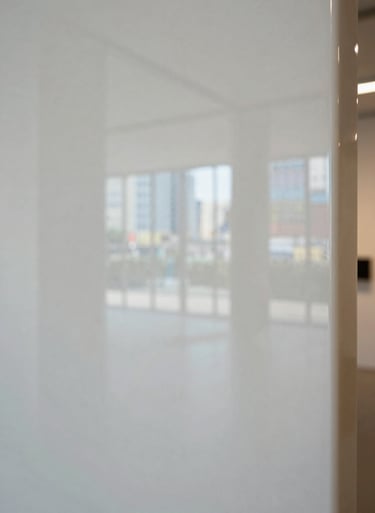 Close-up detail of a polished resin surface, showing reflections of an Almond White gallery space in an International / Global city.