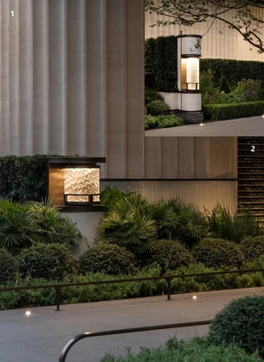 Modern garden with warm outdoor lanterns, soft landscape lighting, green plants and a calm evening a