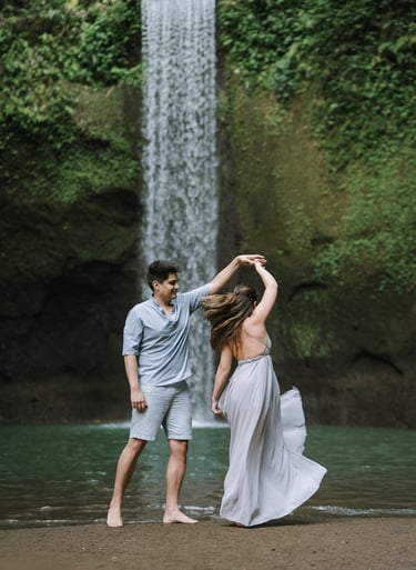 Playful romantic moment during prewedding at Tibumana Waterfall Bangli Bali