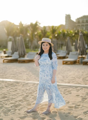 Mother playing with sand during a family photography session at The Apurva Kempinski Bali.
