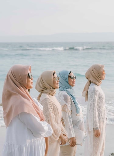 Friends standing together by the ocean during photoshoot at Candi Beach Resort Karangasem Bali