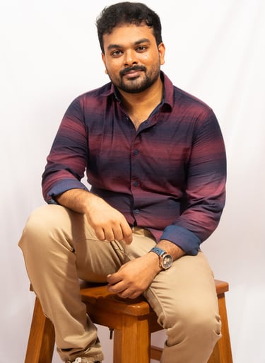 a man sitting on a stool with his feet on a stool