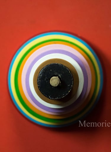a colorful striped vase with a black and white background
