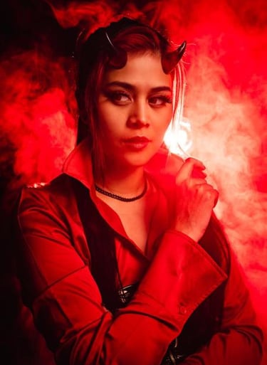 a woman in a red jacket and devil horns with smokes behind her