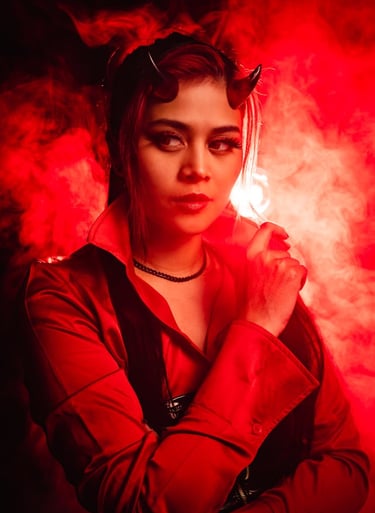 a woman in a devilish costume holding a cigarette