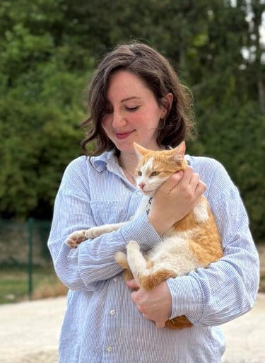 a woman holding a cat in her arms