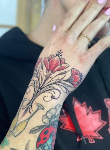 Ornamental flower Tattoo in the woman’s hand. 