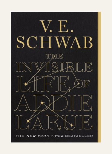 Book cover for The Invisible Life of Addie LaRue by V.E. Schwab featuring gold typography on a black background.