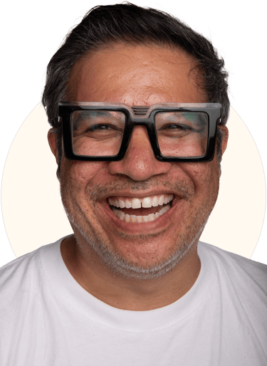 Tio Toto - smiling with black rim glasses and a white shirt