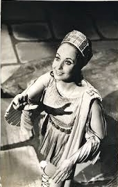 a woman in a dress and earrings